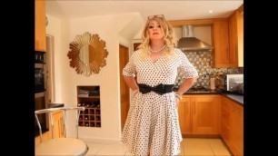 Sindy swishes and teases in white and black spotty dress